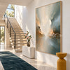 Soft Cream and Sage Cloud Abstract Painting shown beside a staircase.