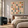 Square Muted Color Circle Grid Wall Art shown above a bed with neutral bedding.