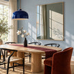 Sunlit Green Wall and Sheer Curtain Painting shown in a dining area.