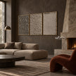 Taupe Texture Study Triptych Wall Art shown above a sofa beside a fireplace.