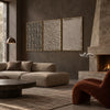 Taupe Texture Study Triptych Wall Art shown above a sofa beside a fireplace.