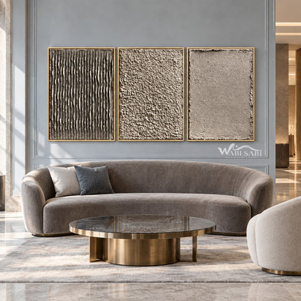 Taupe Texture Study Triptych Wall Art shown above a curved pale sofa.