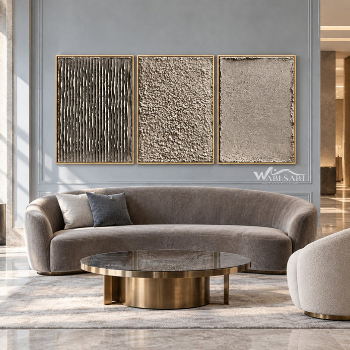 Taupe Texture Study Triptych Wall Art shown above a curved pale sofa.
