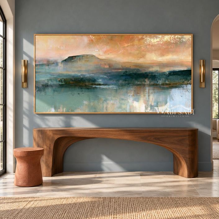 Teal Mountain Lake beneath a Peach Sky shown above a wood console.