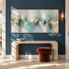 Turquoise Reflections and Gold Horizon Wall Art shown above a fireplace on a dark blue wall.