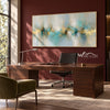 Turquoise Reflections and Gold Horizon Wall Art shown above a desk on a dark red wall.