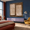 Two Cream Blocks on Brown Abstract Wall Art shown above a bed beside a yellow chair.