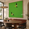 Two Flying Birds on Bright Green Wall Art shown behind a dining table.