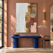 White and Muted Patchwork Abstract Painting shown above a blue console on a pink wall.