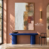White and Muted Patchwork Abstract Painting shown above a blue console on a pink wall.