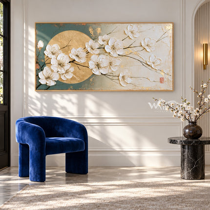 White Blossoms across a Golden Circle Wall Art shown above a blue chair and a side table.