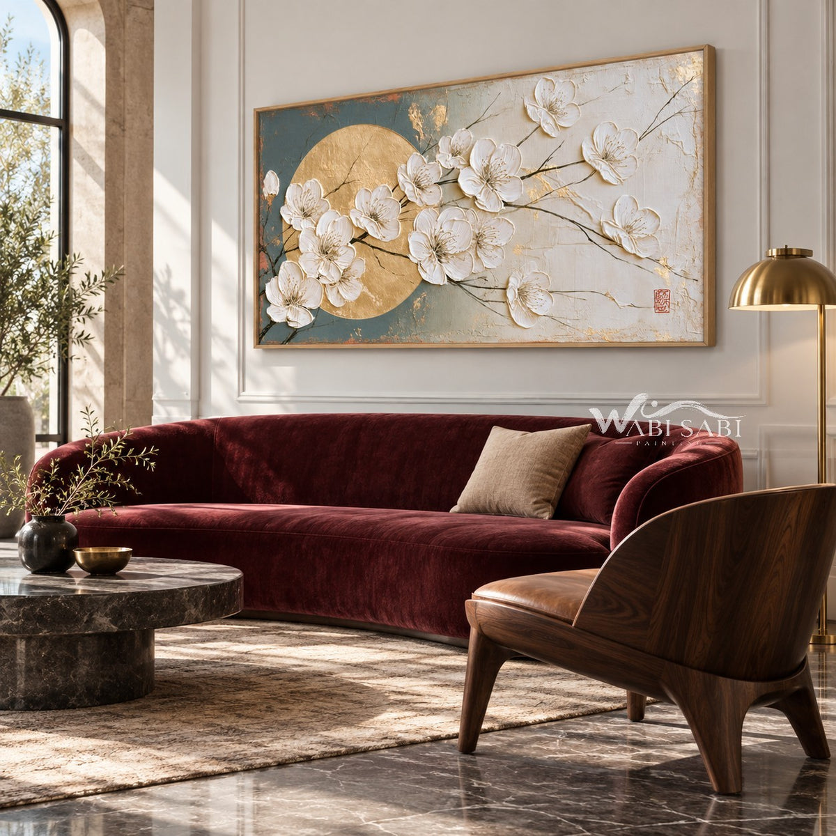 White Blossoms across a Golden Circle Wall Art shown above a burgundy sofa.