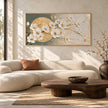 White Blossoms across a Golden Circle Wall Art shown above a pale sofa.