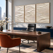 White Folded Ridges Triptych Wall Art shown in a workspace.