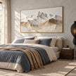 Wide White Mountain Range Wall Art shown above a bed with blue bedding.