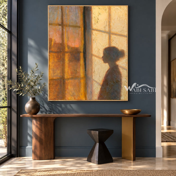 Window at Dusk with a Figure in Profile shown above a dark console on a blue wall.